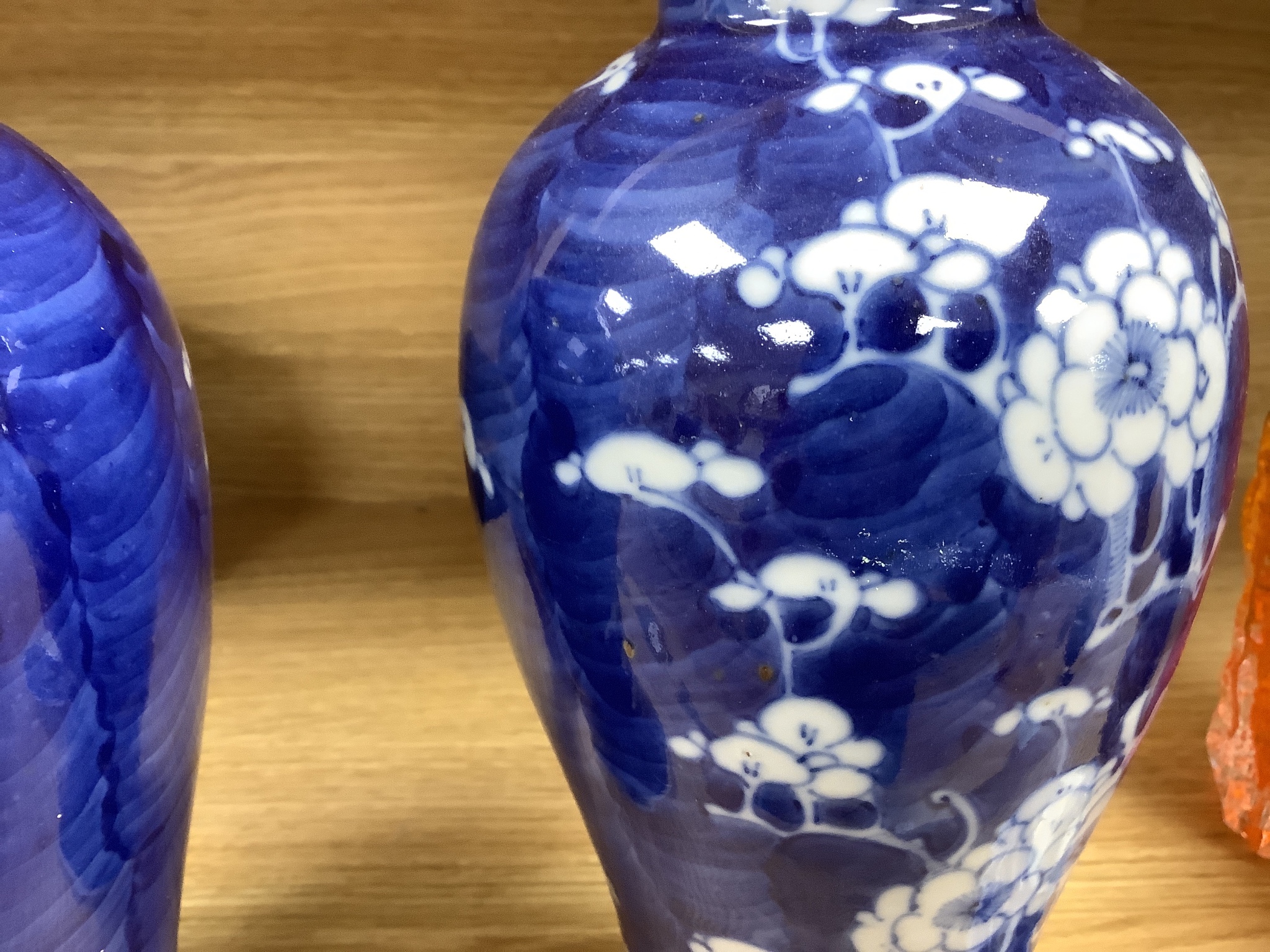 A pair of early 20th century Chinese blue and white prunus vases and covers, height 30cm